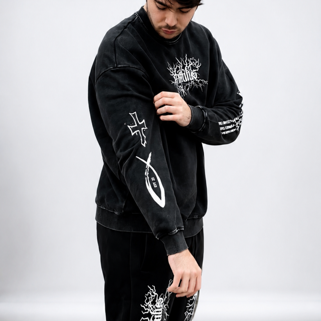 Person wearing a black outfit with white designs on a white background