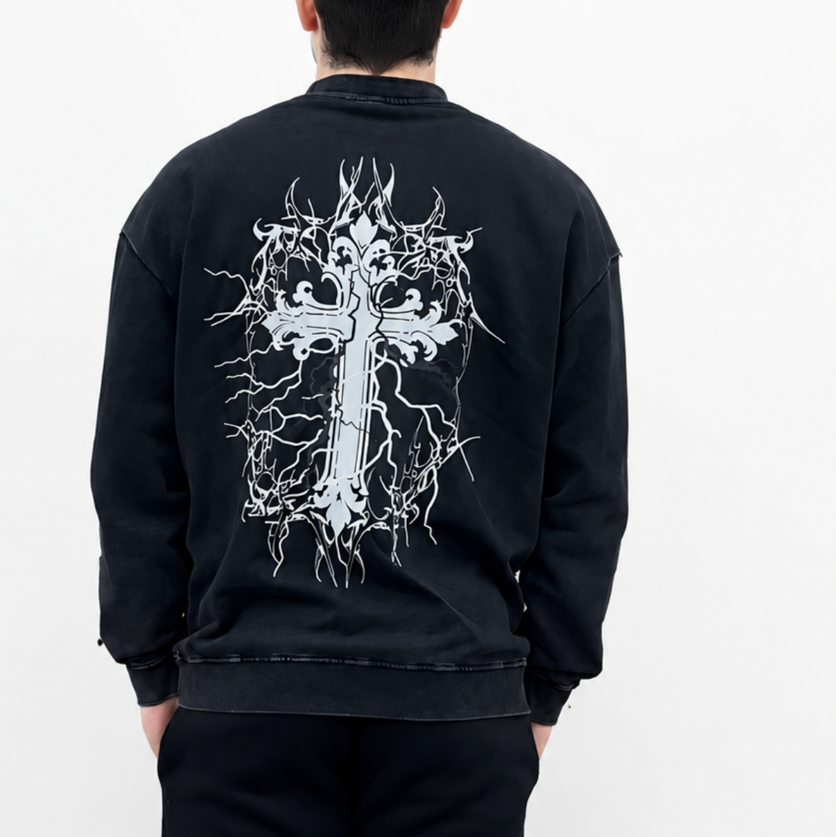 Person wearing a black sweatshirt with a white graphic design on the back against a white background