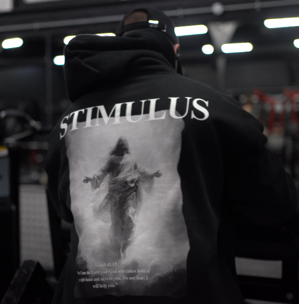 Black jacket with 'STIMULUS' design on a blurred indoor background