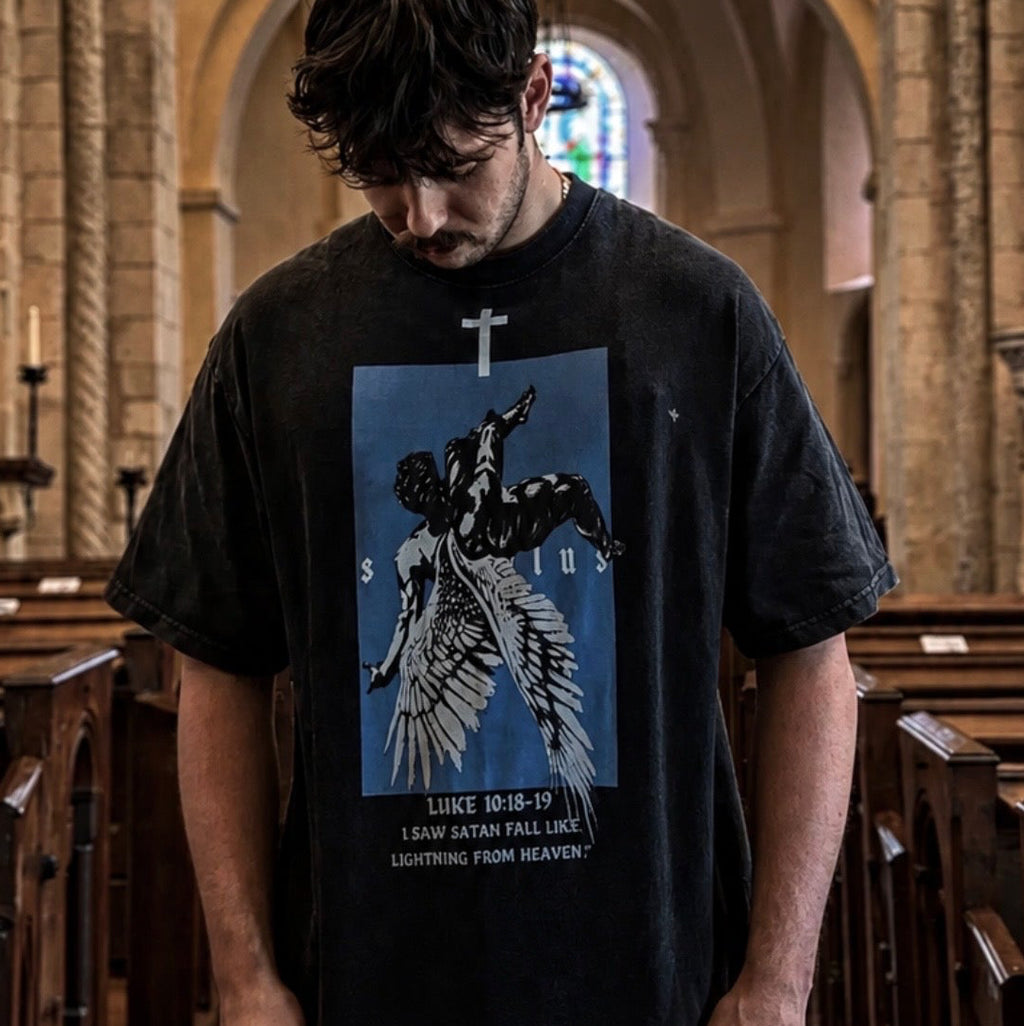 Person wearing a black t-shirt with a graphic design in a church setting