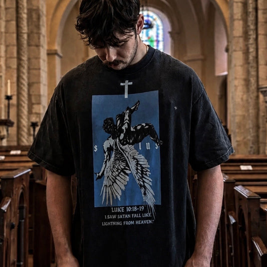 Person wearing a black t-shirt with a graphic design in a church setting