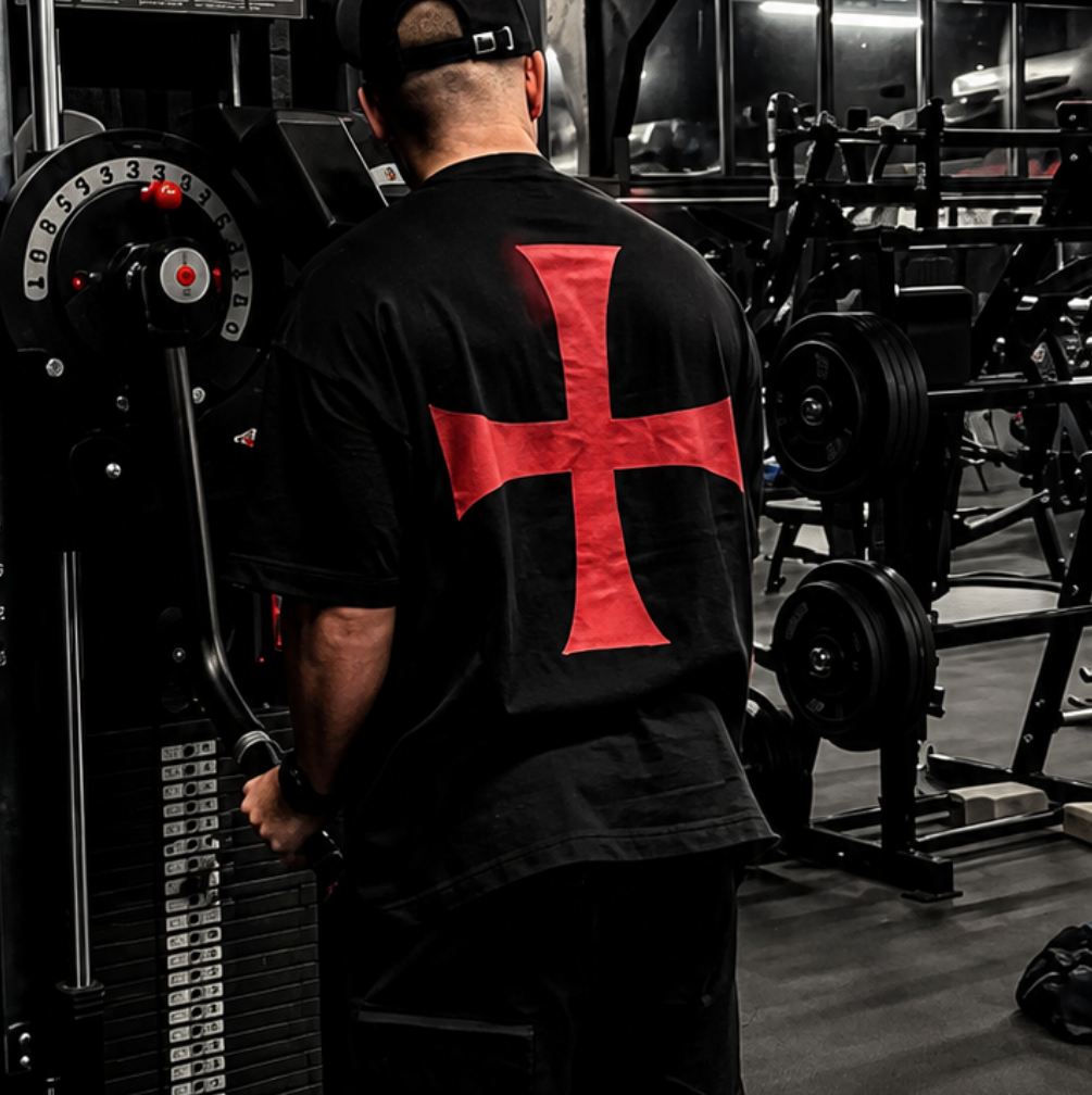 Person wearing a black and red outfit in a gym setting